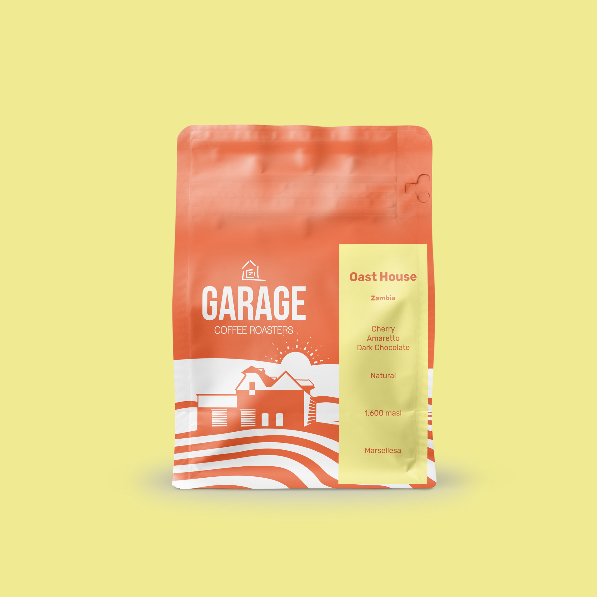 An orange Garage Coffee bag of Oast House Single Origin Espresso coffee. The coffee is a natural, Marsellesa varietal and from Zambia. It grew at 1,600 masl and tastes like Cherry, Amaretto, and dark chocolate.